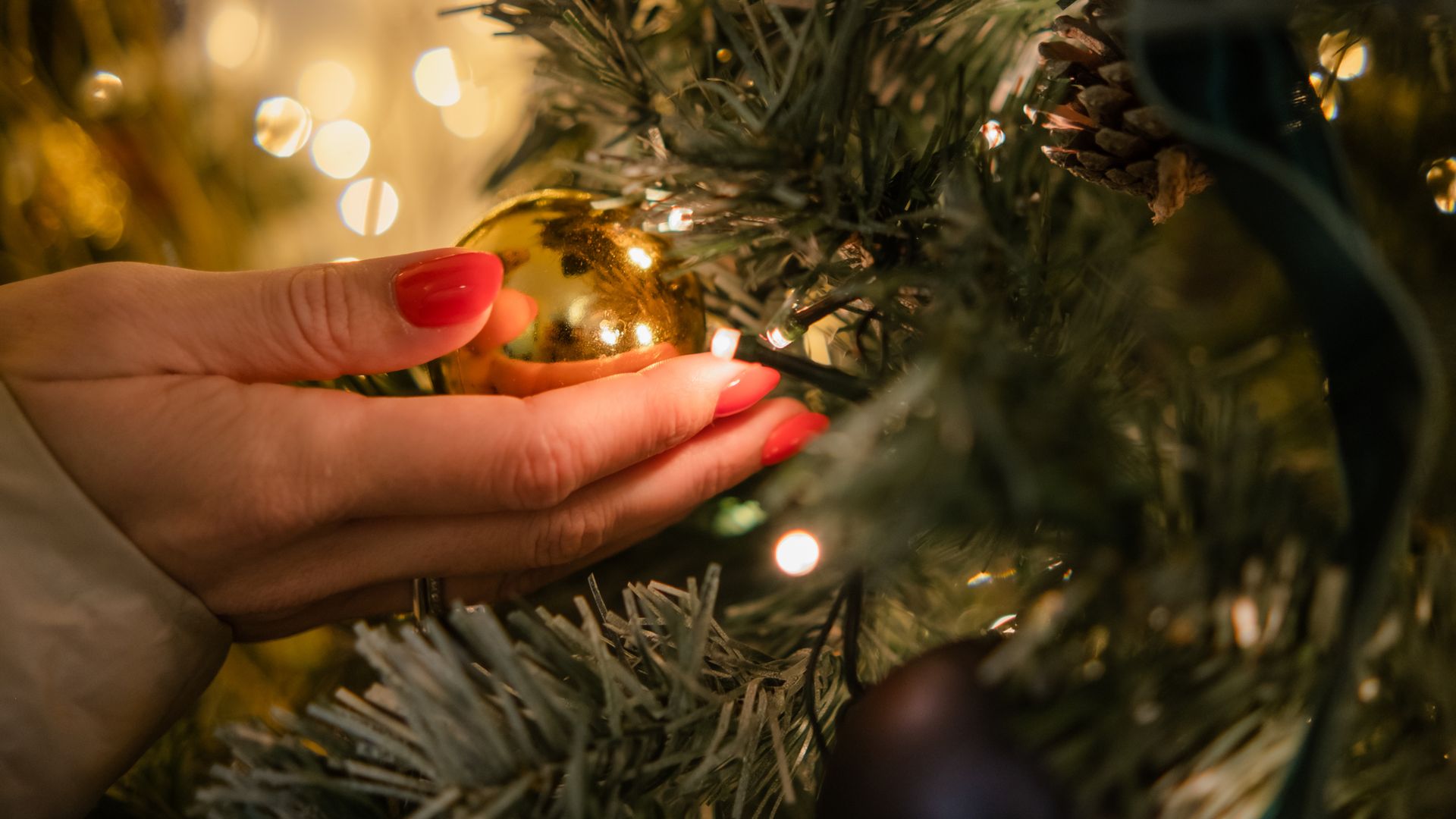 Christmas golden ball in a woman's palm