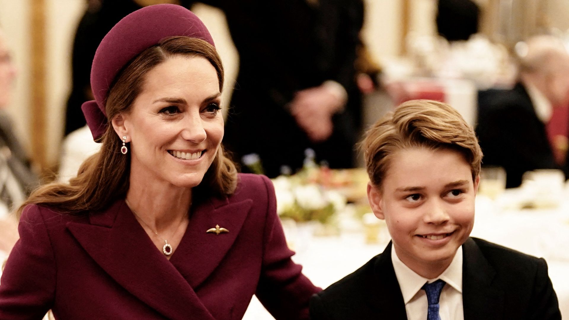 Kate and George smiling with veterans